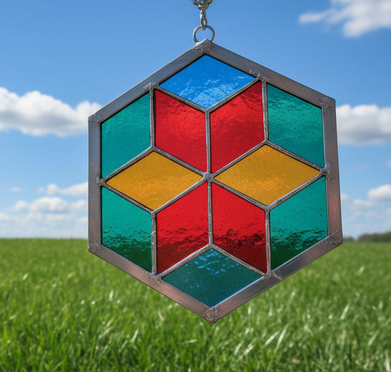 Hexagonal stained glass panel with colorful geometric design on a plain background