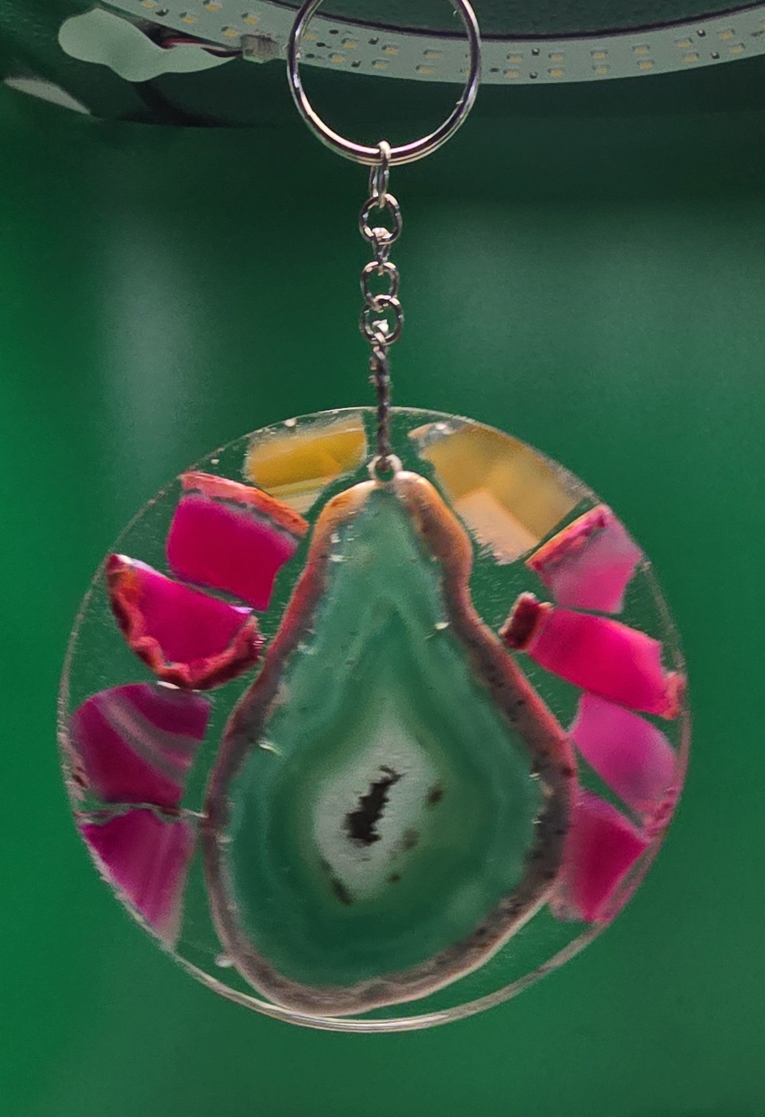A circular resin suncatcher with agate