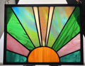 Stained glass panel with colorful design on a black frame